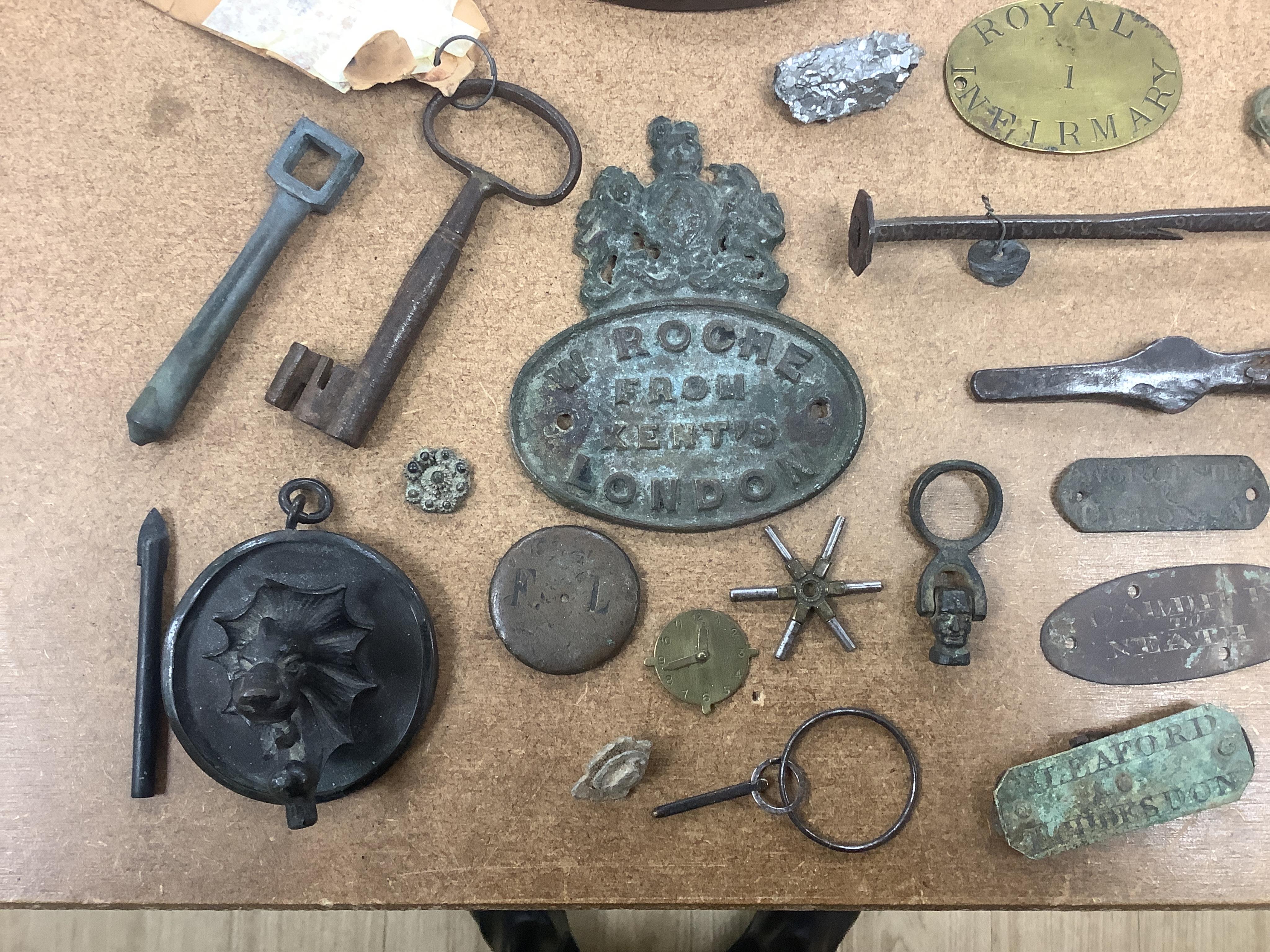 A box of 19th/20th century metal plaques, scales, ornaments etc. Condition - varies